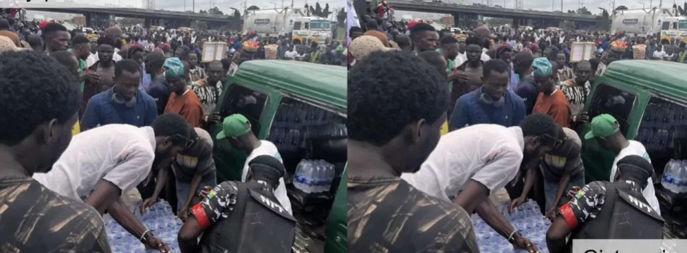 Police Shows Solidarity, Shares ‘Bottle Water’ With Protesters In Lagos (Watch Video)